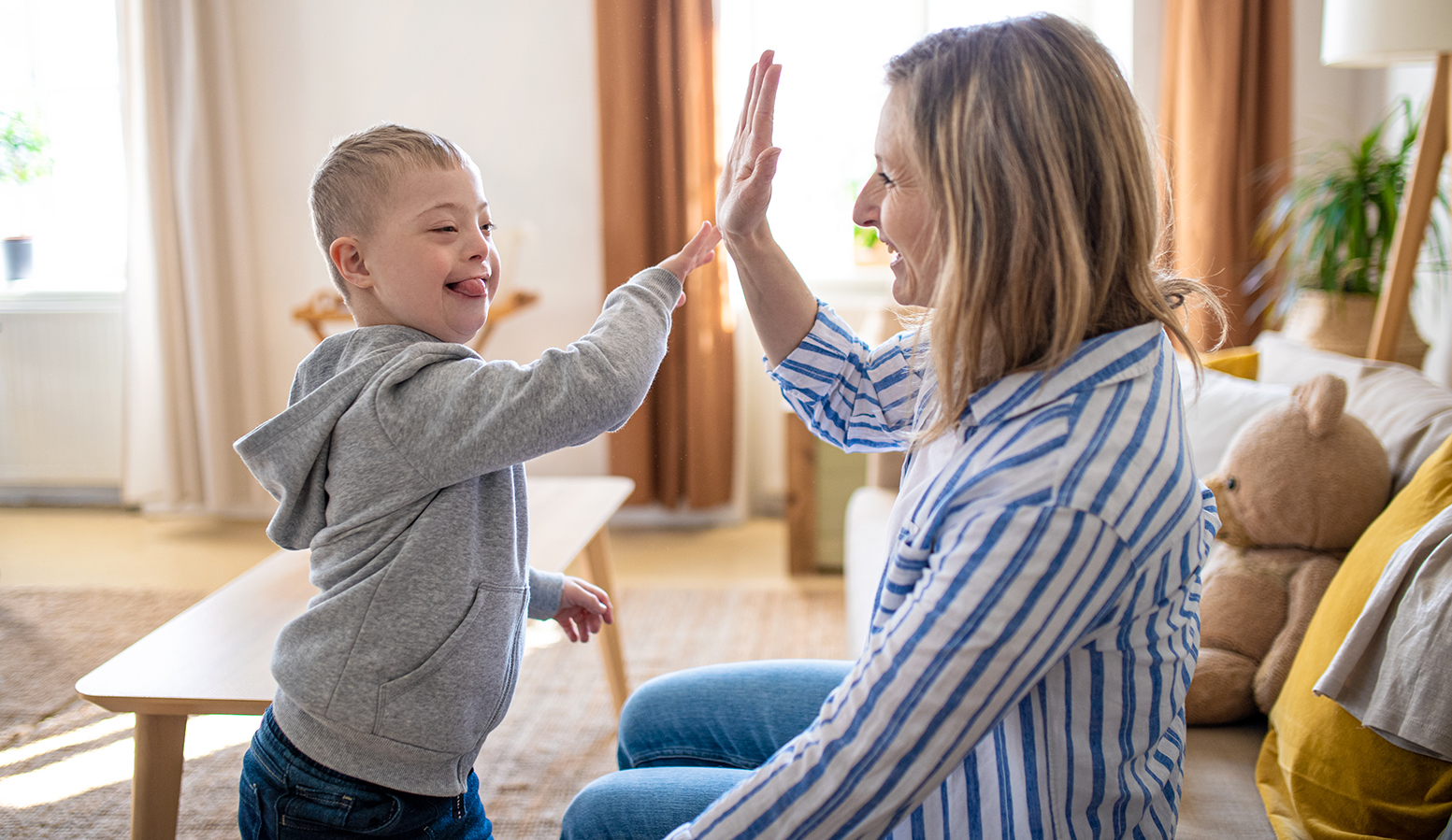 Woman playing with down syndrome child